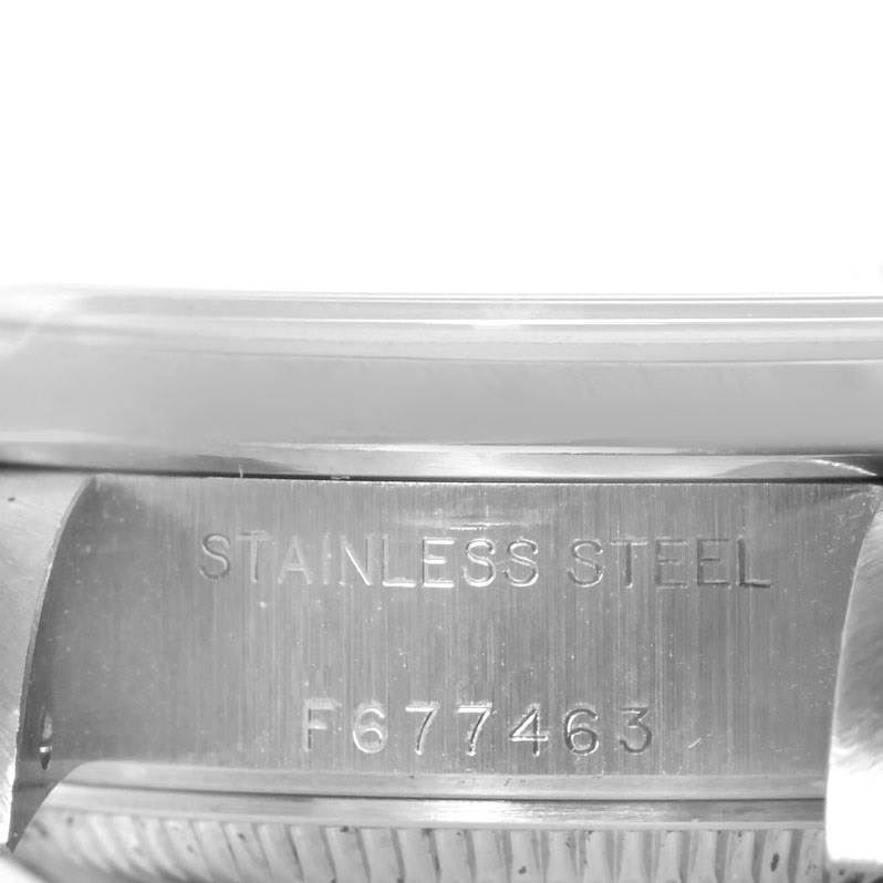The image shows a close-up of the case side of a Rolex Date 79160 Women's Stainless Steel Beige Dial 79160 Women's Stainless Steel Beige Dial model, displaying the serial number and "STAINLESS STEEL" engraving.