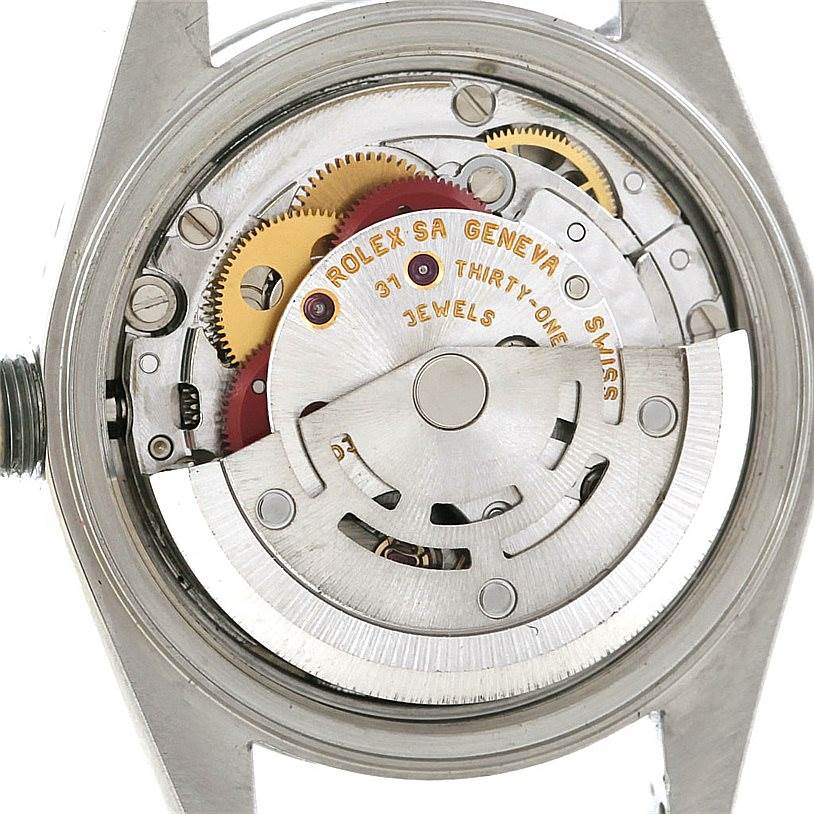 This image shows the internal mechanical movement of a Rolex Date 79240 Women's Stainless Steel Silver Dial 79240 Women's Stainless Steel Silver Dial model watch, viewed from the back with various gears and parts visible.
