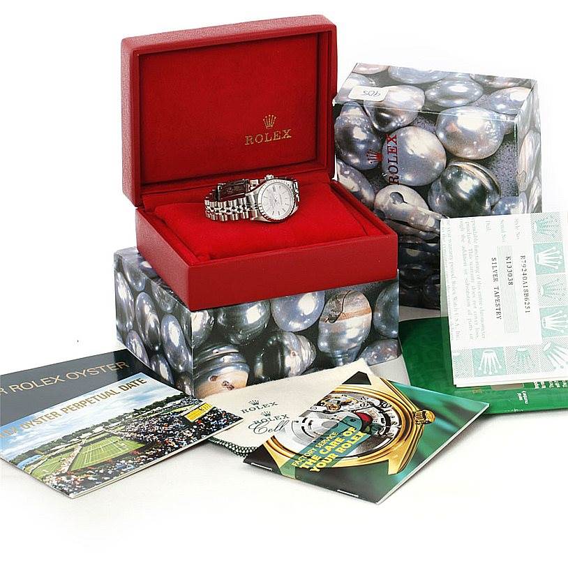 The Rolex Date 79240 Women's Stainless Steel Silver Dial 79240 Women's Stainless Steel Silver Dial model watch is shown in an open red box, along with various booklets and certification papers.