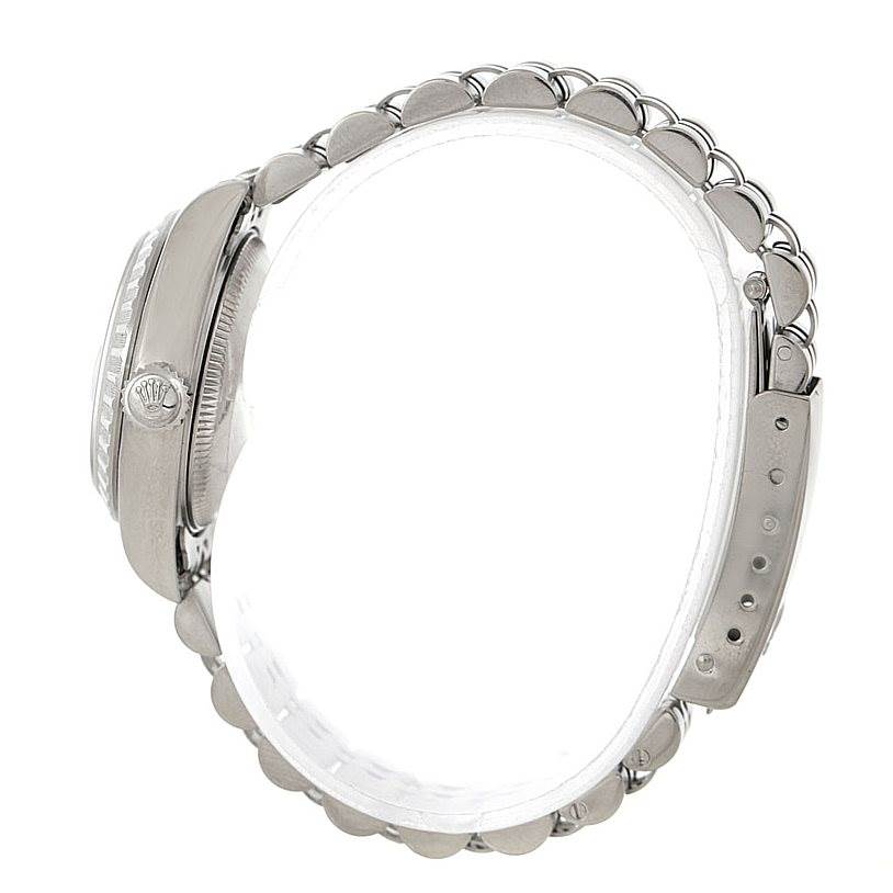 This side view image of a Rolex Date 79240 Women's Stainless Steel Silver Dial 79240 Women's Stainless Steel Silver Dial model watch shows the crown and part of the metal bracelet.