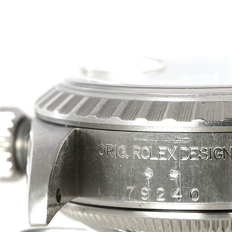 This image shows a close-up side view of the case, bezel, and serial engraving on a Rolex Date 79240 Women's Stainless Steel Silver Dial 79240 Women's Stainless Steel Silver Dial model watch.