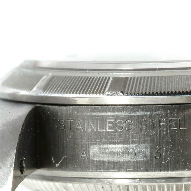 This close-up angle shows the side of the stainless steel case of the Rolex Date 79190 Women's Stainless Steel Pink Dial 79190 Women's Stainless Steel Pink Dial model, highlighting the engraved serial number.