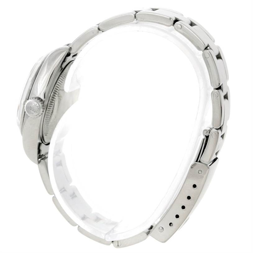 This is a side view of a Rolex Date 79190 Women's Stainless Steel Pink Dial 79190 Women's Stainless Steel Pink Dial model watch, showing its crown, case, and bracelet.