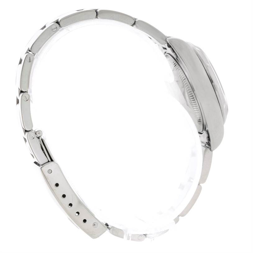 This side angle view of the Rolex Date 79190 Women's Stainless Steel Pink Dial 79190 Women's Stainless Steel Pink Dial model showcases its metal bracelet and case.