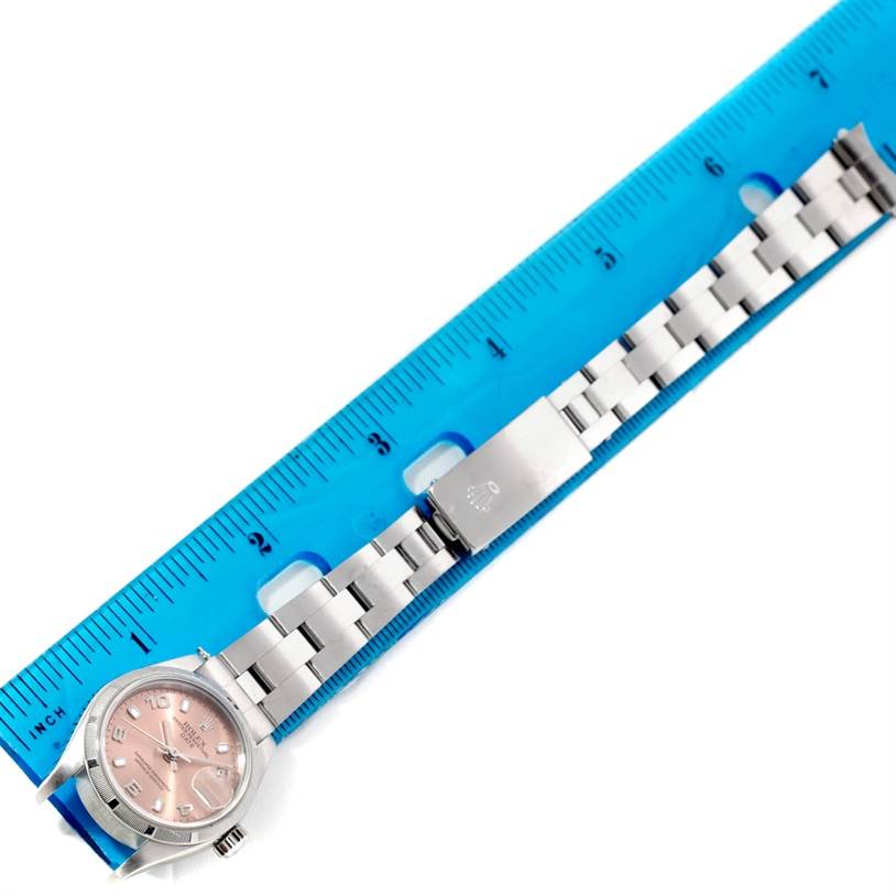 This Rolex Date 79190 Women's Stainless Steel Pink Dial 79190 Women's Stainless Steel Pink Dial watch is laid flat next to a blue ruler, showing the face and entire bracelet.