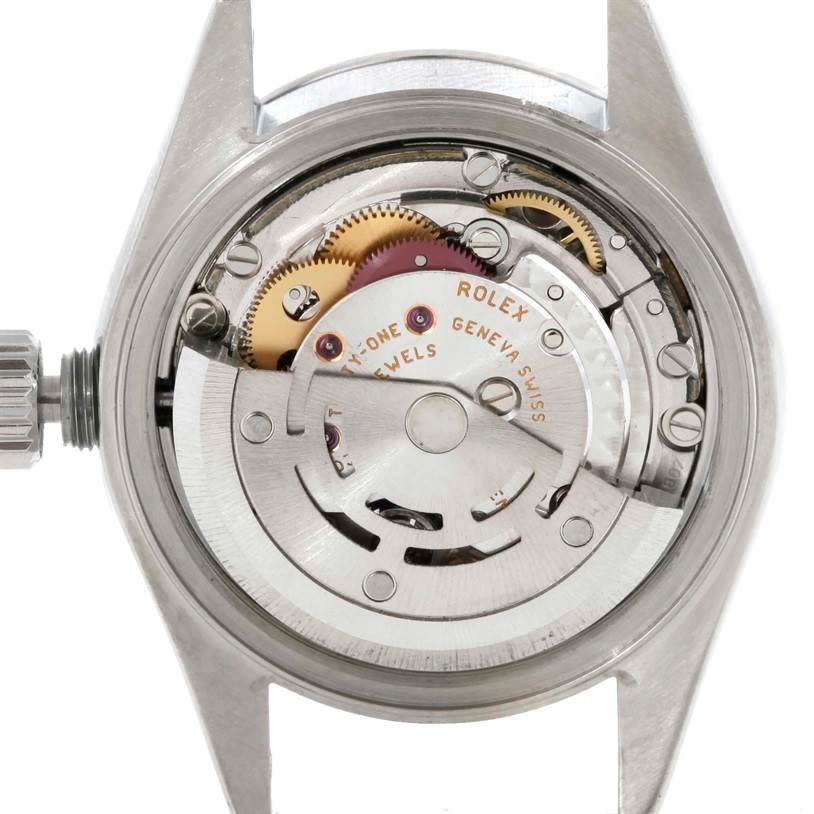 The image shows the back view of the Rolex Date 79160 Women's Stainless Steel White Dial 79160 Women's Stainless Steel White Dial model watch, highlighting its intricate movement and rotor mechanism.