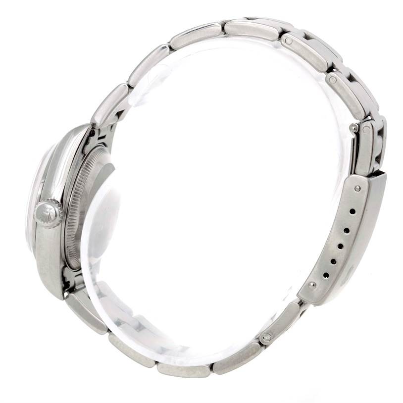 The image shows a side view of a Rolex Date 79160 Women's Stainless Steel White Dial 79160 Women's Stainless Steel White Dial watch, focusing on the crown, bezel, and metal bracelet.