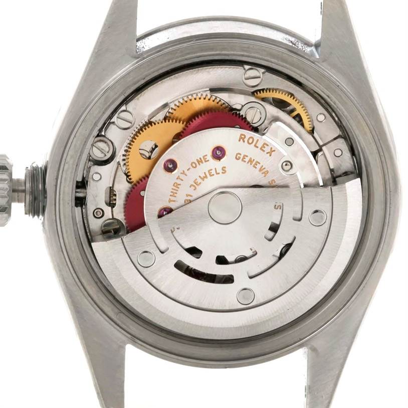 This is a close-up of the internal mechanism of a Rolex Date 79240 Women's Stainless Steel White Dial 79240 Women's Stainless Steel White Dial model watch, showcasing gears and the rotor.