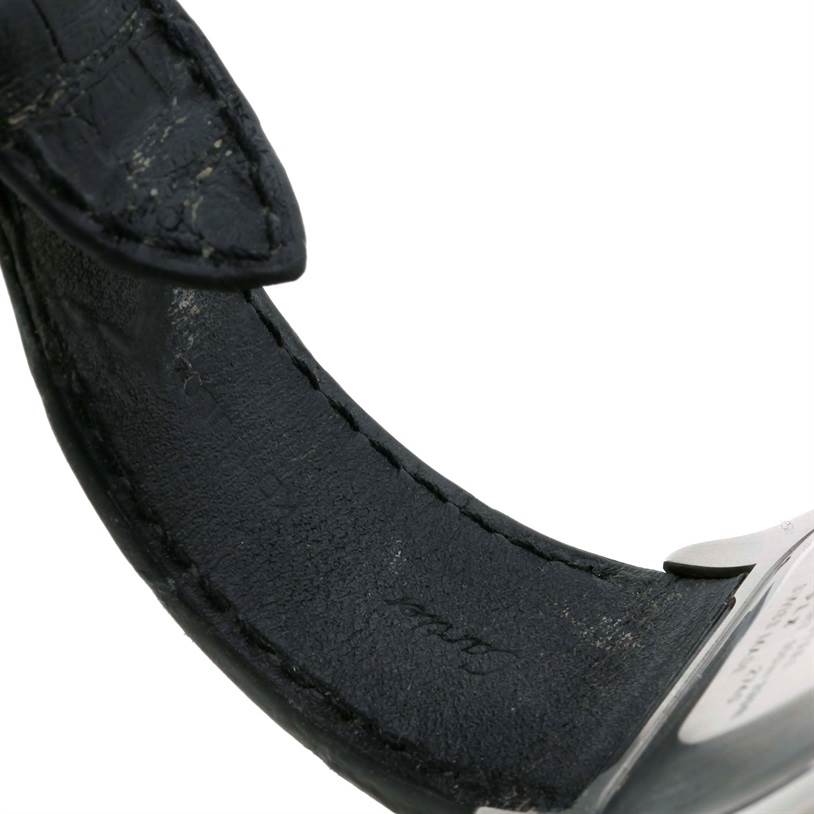 The image shows a close-up of the leather strap and a part of the buckle of a Cartier Santos W20090X8 Stainless Steel Silver Dial W20090X8 Stainless Steel Silver Dial watch.