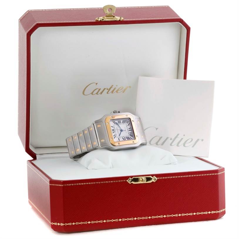 The Cartier Santos W20099C4 Men
s Stainless Steel Silver Dial W20099C4 Men
s Stainless Steel Silver Dial watch is shown at an angle inside its open red box, with the brand name visible on a white inner card.