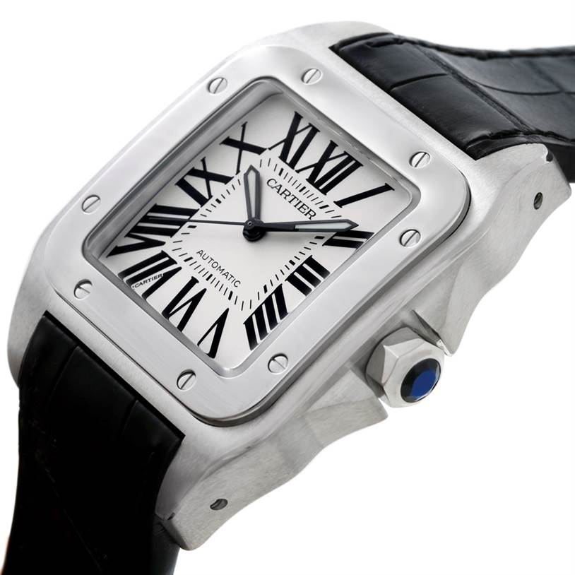 The image shows a Santos model by Cartier, viewed at a slight angle to display its face, bezel, crown, and black strap.