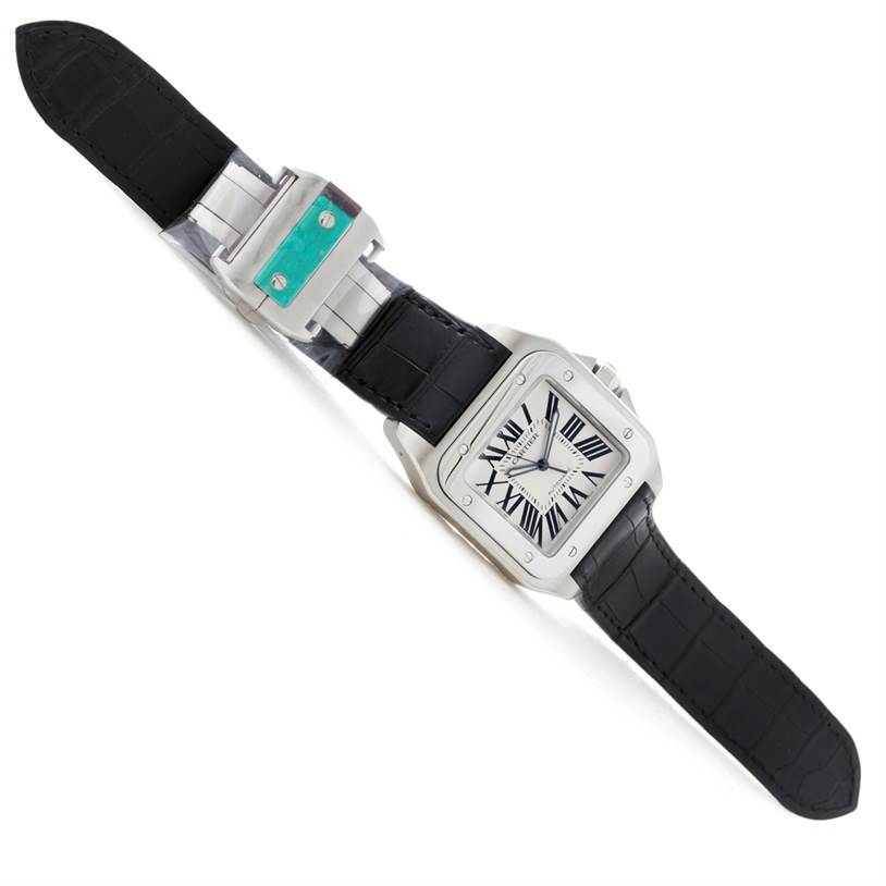 The image shows a Santos model by Cartier, featuring a square face, Roman numerals, and a black leather strap.