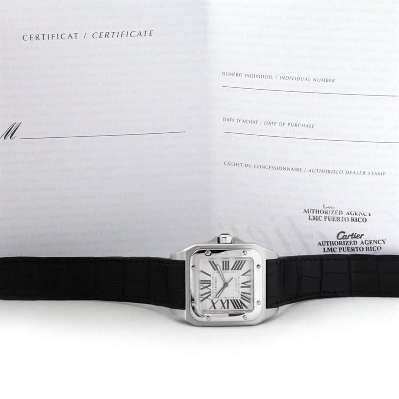 The image shows the front view of a Cartier Santos W20073X8 Men's Stainless Steel Silver Dial W20073X8 Men's Stainless Steel Silver Dial watch laying flat, alongside its certificate and documentation.