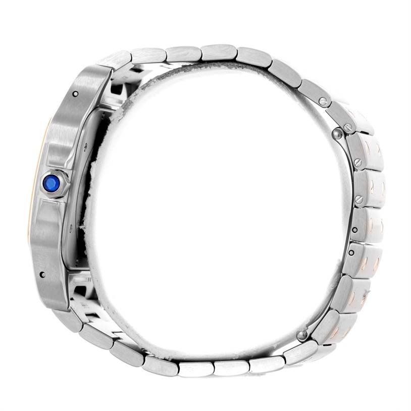 The image shows a side profile of a Santos model by Cartier, featuring the bracelet and crown with a blue cabochon.