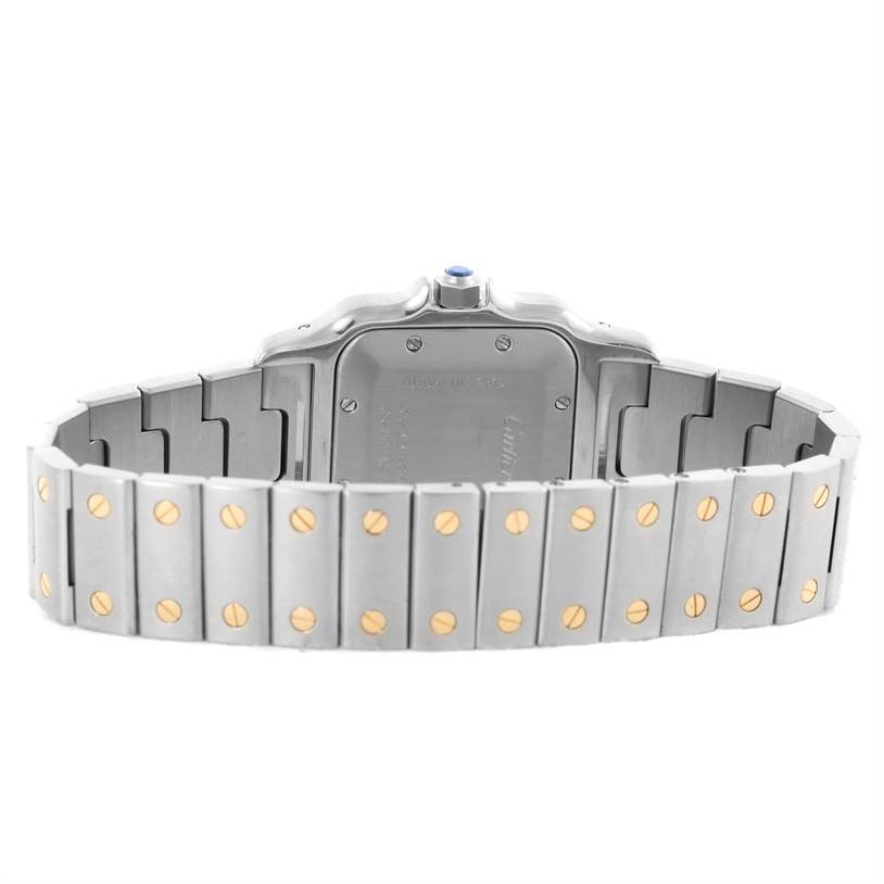 The image shows the back and bracelet of a Cartier Santos W20058C4 Men's Stainless Steel Silver Dial W20058C4 Men's Stainless Steel Silver Dial watch, highlighting its metal links and gold screws.