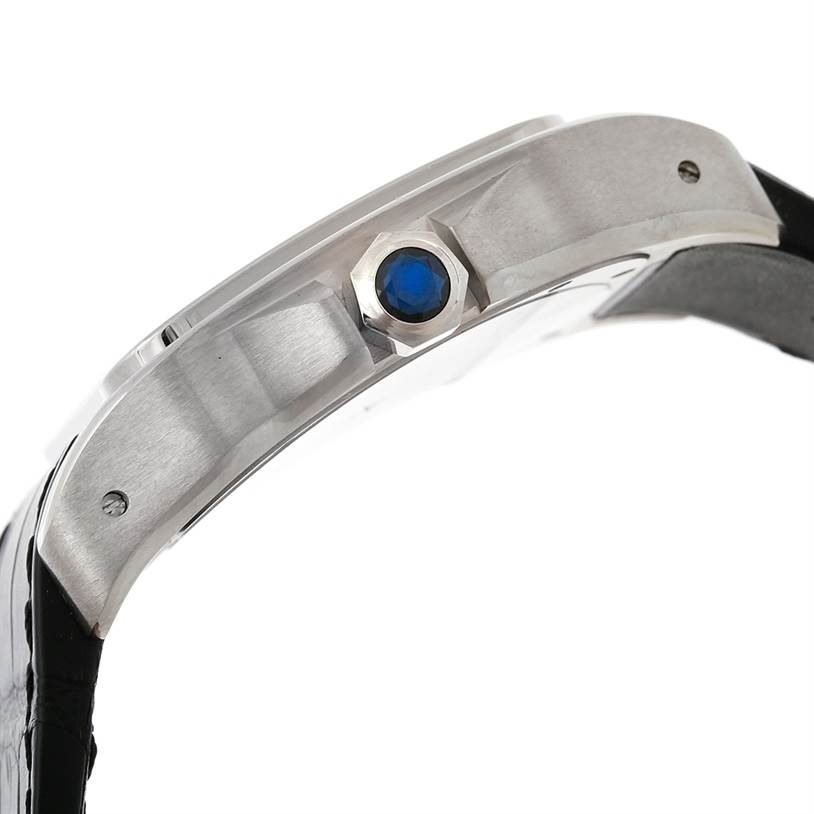 The image shows a side view of the Cartier Santos W20073X8 Men's Stainless Steel Silver Dial W20073X8 Men's Stainless Steel Silver Dial watch, highlighting the crown with a blue cabochon.