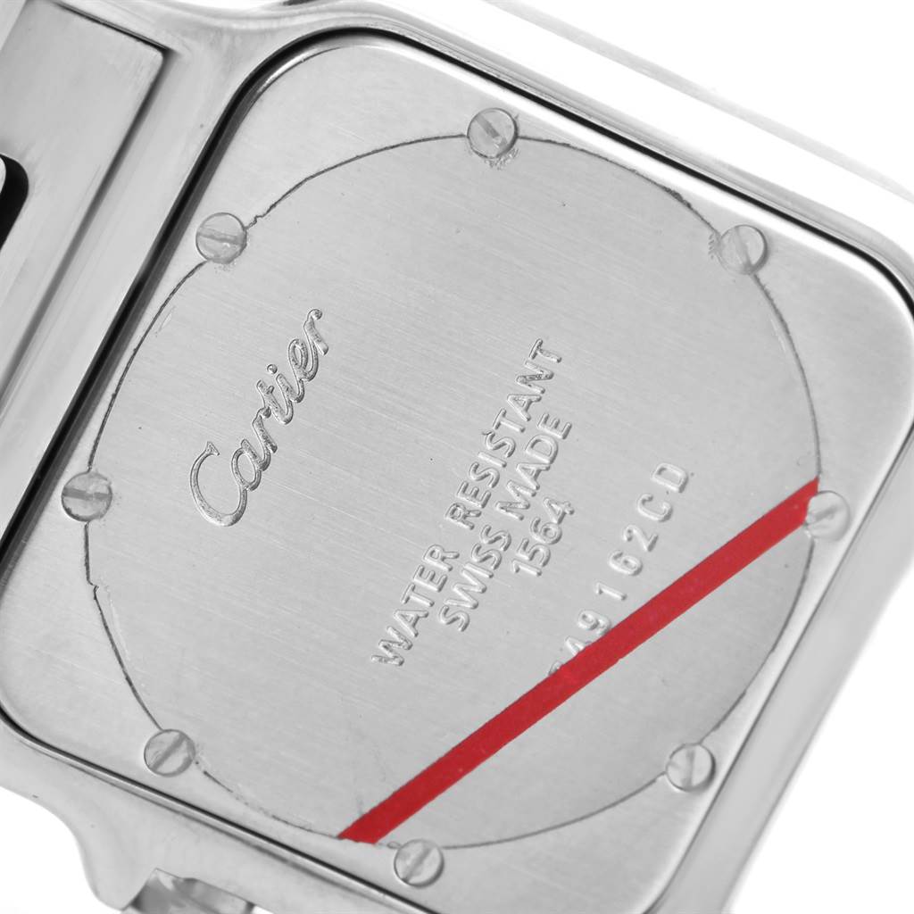 The image shows the case back of a Cartier Santos W20060D6 Men
s Stainless Steel Silver Dial W20060D6 Men
s Stainless Steel Silver Dial watch, featuring engraved details and screws.