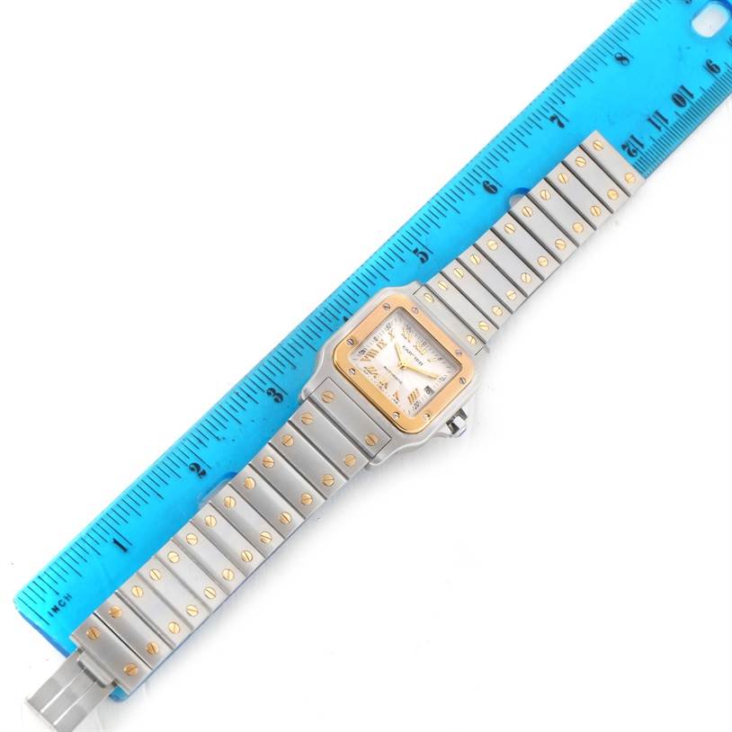 The Cartier Santos W20058C4 Men's Stainless Steel Silver Dial W20058C4 Men's Stainless Steel Silver Dial watch is shown from a top-down angle, showcasing the face, bezel, and metal bracelet.