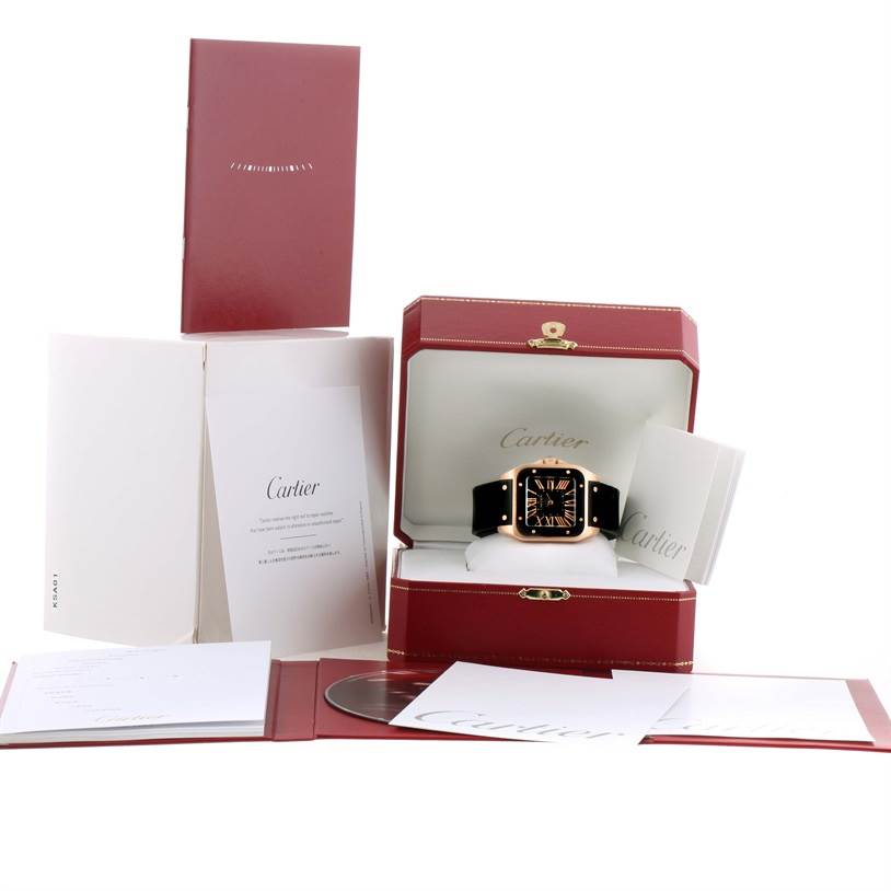 The image shows a Cartier Santos W20124U2 Men
s Rose Gold Black Dial W20124U2 Men
s Rose Gold Black Dial watch in its presentation box, with booklets and documentation displayed around it.