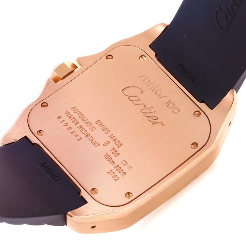 The image shows the case back of a Cartier Santos W20124U2 Men
s Rose Gold Black Dial W20124U2 Men
s Rose Gold Black Dial watch, highlighting its engravings and adjacent strap parts.