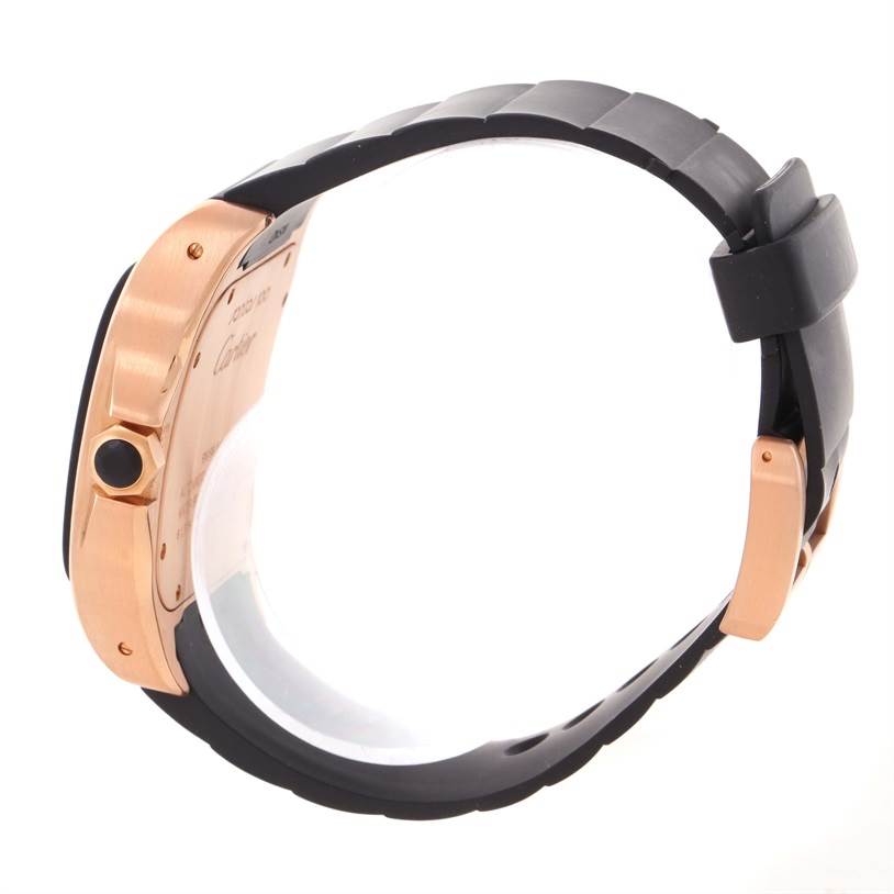 The image shows a side view of the Cartier Santos W20124U2 Men
s Rose Gold Black Dial W20124U2 Men
s Rose Gold Black Dial watch, highlighting its case back and black strap.