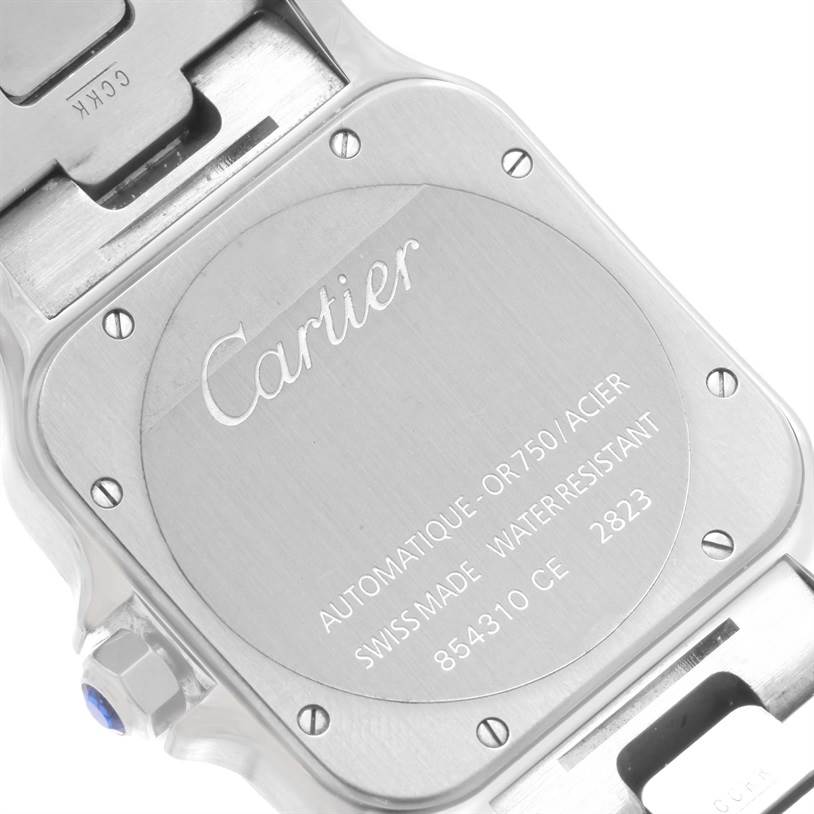 This image shows the back case of a Cartier Santos W20099C4 Men's Stainless Steel Silver Dial W20099C4 Men's Stainless Steel Silver Dial watch at an angled close-up view, highlighting the engraved brand details.