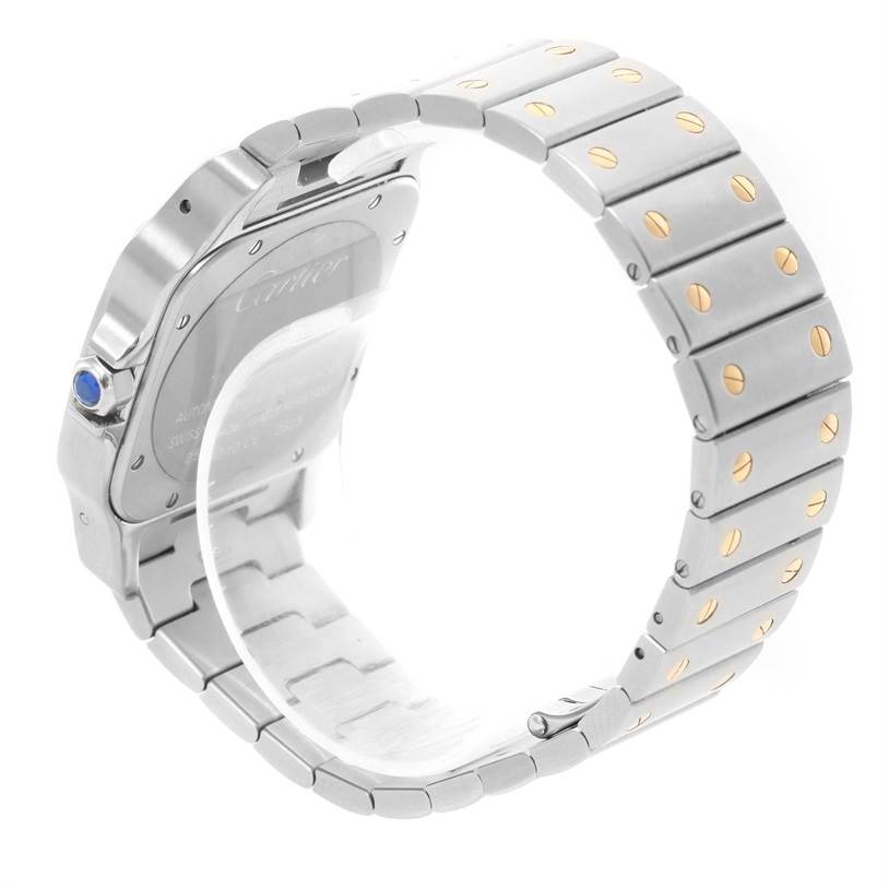 The image shows the back view and part of the bracelet of a Cartier Santos W20099C4 Men's Stainless Steel Silver Dial W20099C4 Men's Stainless Steel Silver Dial watch with visible screws and a blue cabochon on the crown.