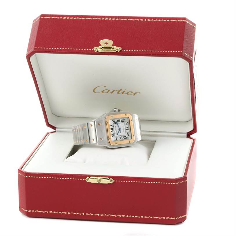 The Cartier Santos W20099C4 Men's Stainless Steel Silver Dial W20099C4 Men's Stainless Steel Silver Dial watch is displayed inside an open red Cartier box, showing the face and bracelet at a slight top angle.