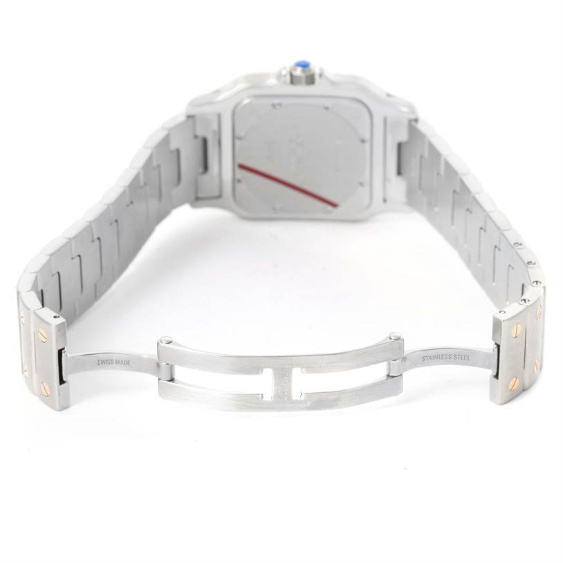 The image shows the open clasp and back of the stainless steel bracelet of a Santos model by Cartier.