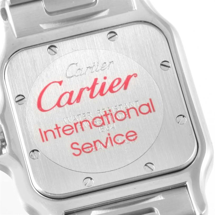 The image shows the back case of a Santos model watch by Cartier at a close-up angle.