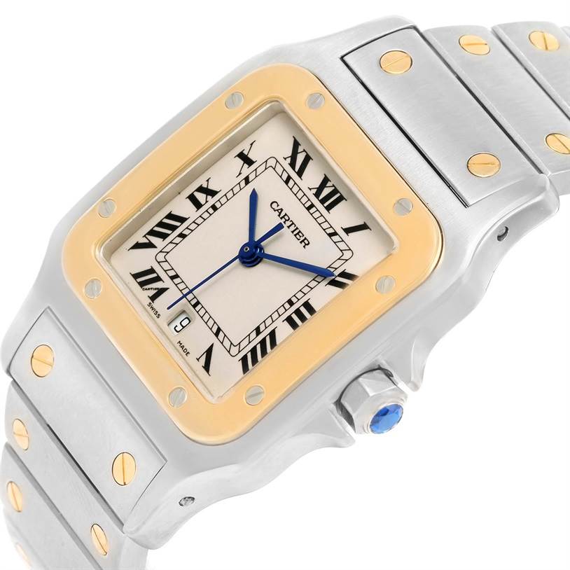 The image shows a Santos model Cartier watch at an angled close-up, displaying its face, bezel, and part of the bracelet.