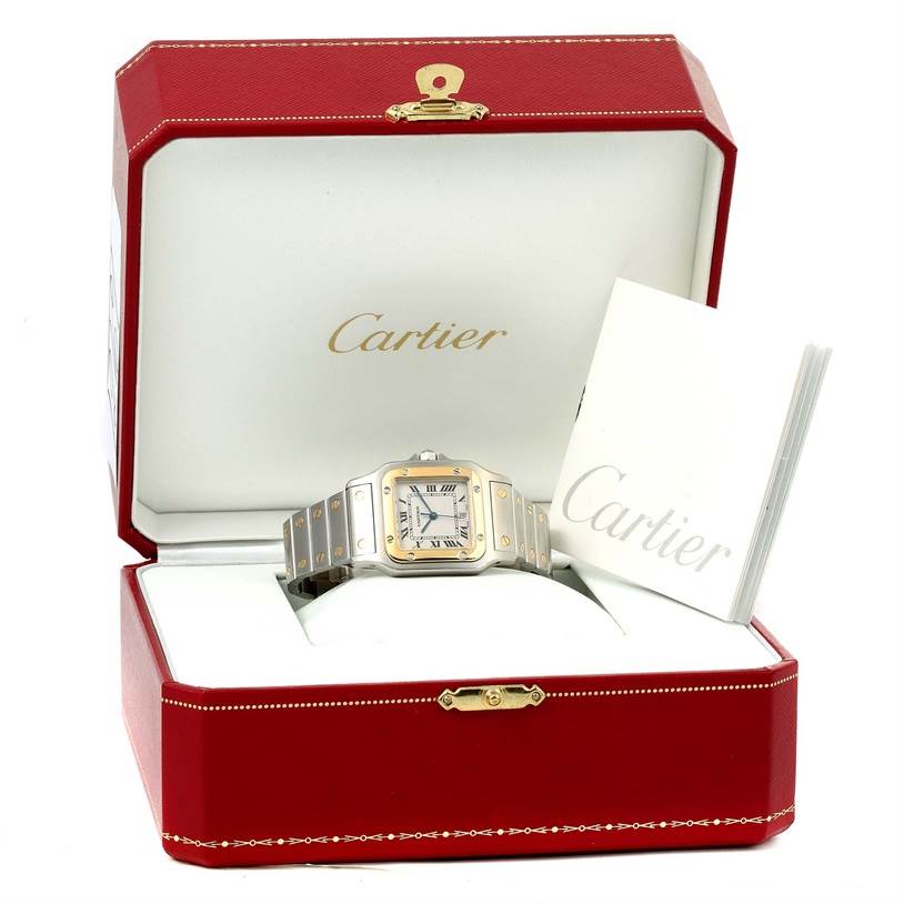 The image shows a Cartier Santos W20011C4 Stainless Steel Silver Dial W20011C4 Stainless Steel Silver Dial watch in its open red box along with a booklet.