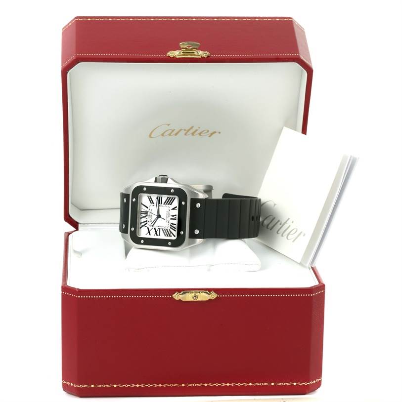 The image shows a Cartier Santos W20121U2 Men
s Stainless Steel Silver Dial W20121U2 Men
s Stainless Steel Silver Dial watch placed in its open red and white Cartier box, along with accompanying documentation.