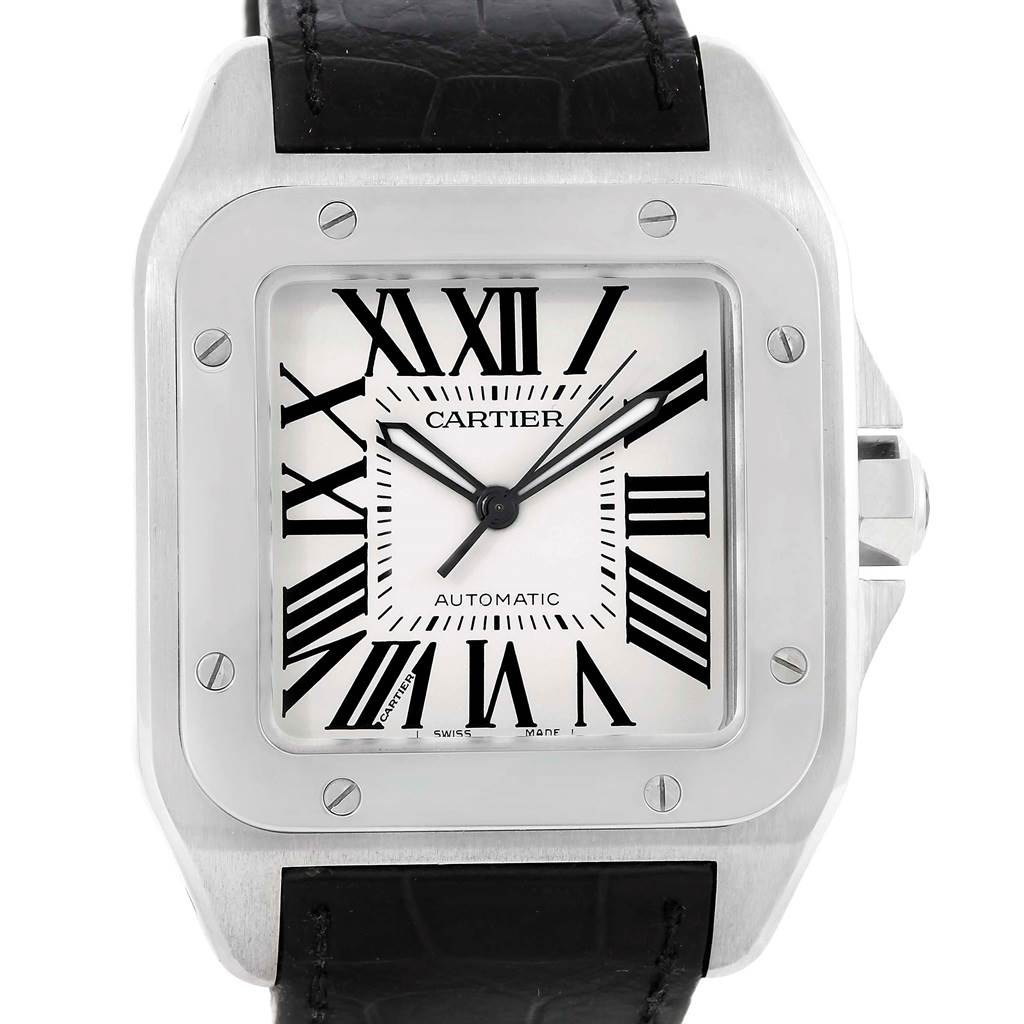 The image shows a close-up of the face and bezel of a Cartier Santos W20073X8 Men's Stainless Steel Silver Dial W20073X8 Men's Stainless Steel Silver Dial watch with a black leather strap.