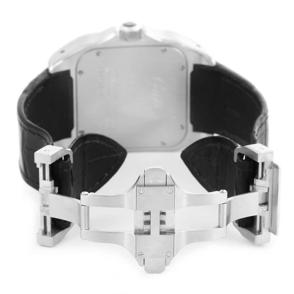 The image shows the back view of a Santos model watch by Cartier, focusing on the stainless steel clasp and black leather strap.