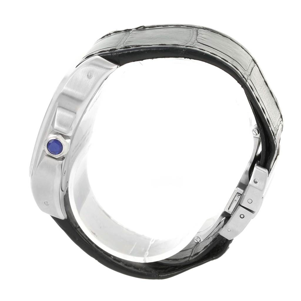 The image shows a side view of a Cartier Santos W20073X8 Men's Stainless Steel Silver Dial W20073X8 Men's Stainless Steel Silver Dial watch, highlighting its case, crown with a blue cabochon, and leather strap.