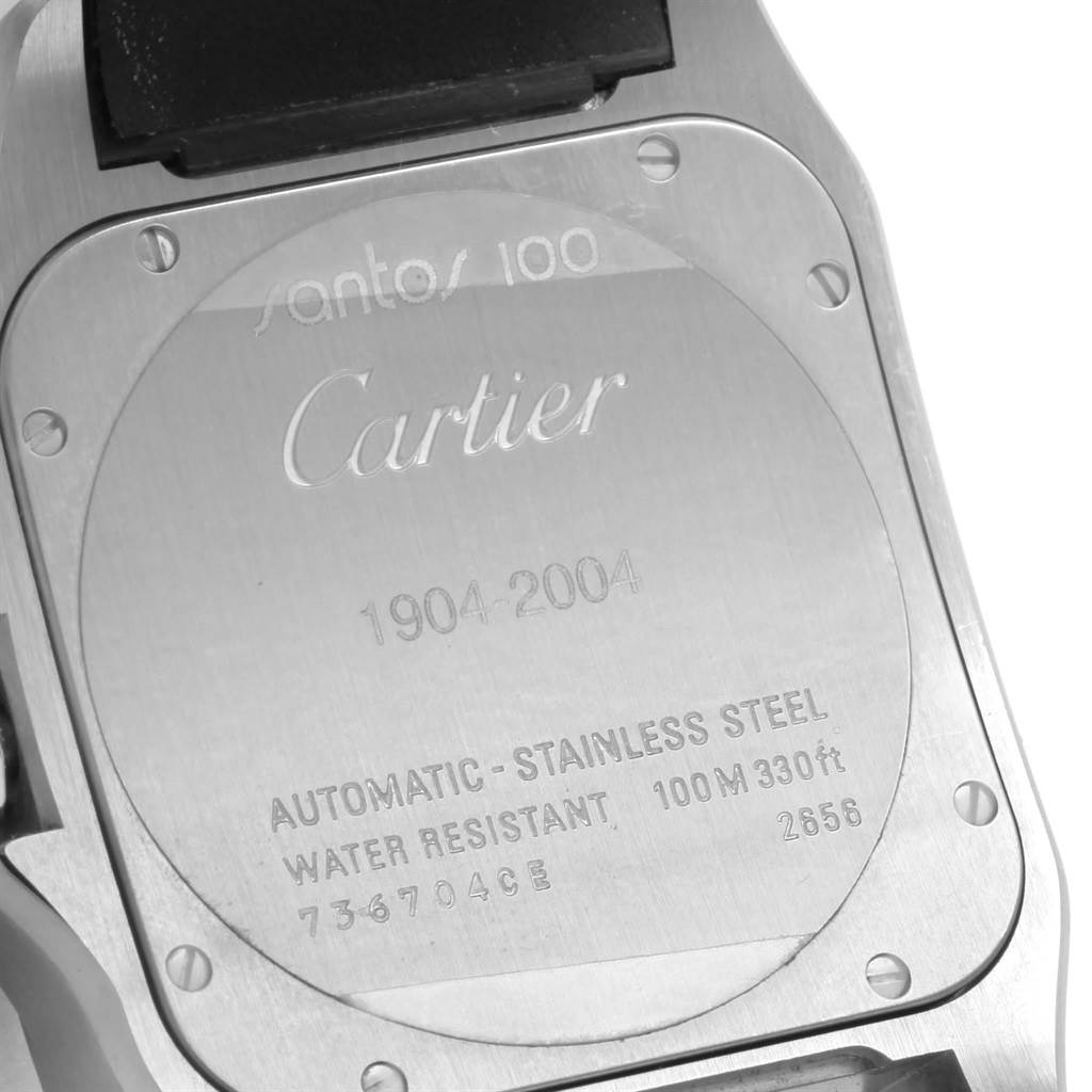 The image shows the back case of a Cartier Santos W20073X8 Men
s Stainless Steel Silver Dial W20073X8 Men
s Stainless Steel Silver Dial 100 watch, including engraved details and screws.