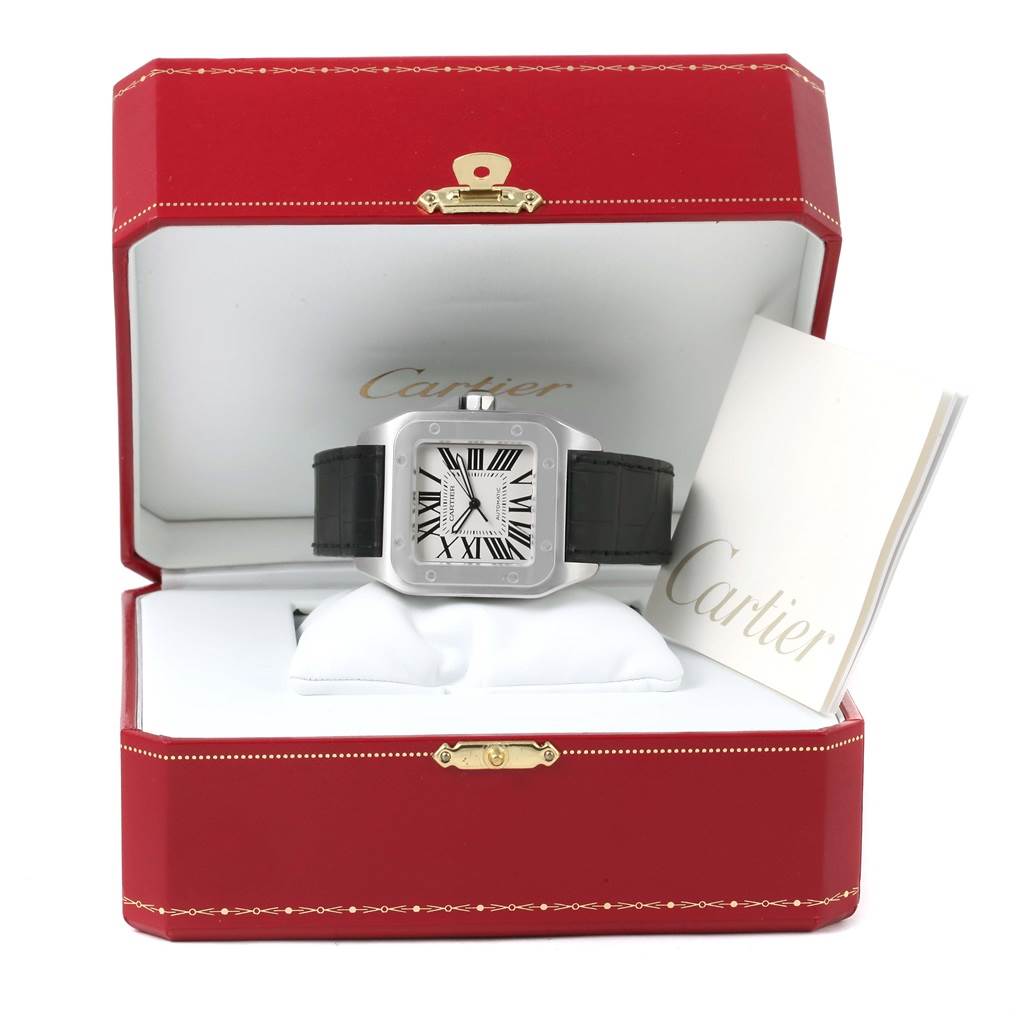 The Cartier Santos W20073X8 Men
s Stainless Steel Silver Dial W20073X8 Men
s Stainless Steel Silver Dial watch is displayed head-on inside a red Cartier box, with a booklet next to it.