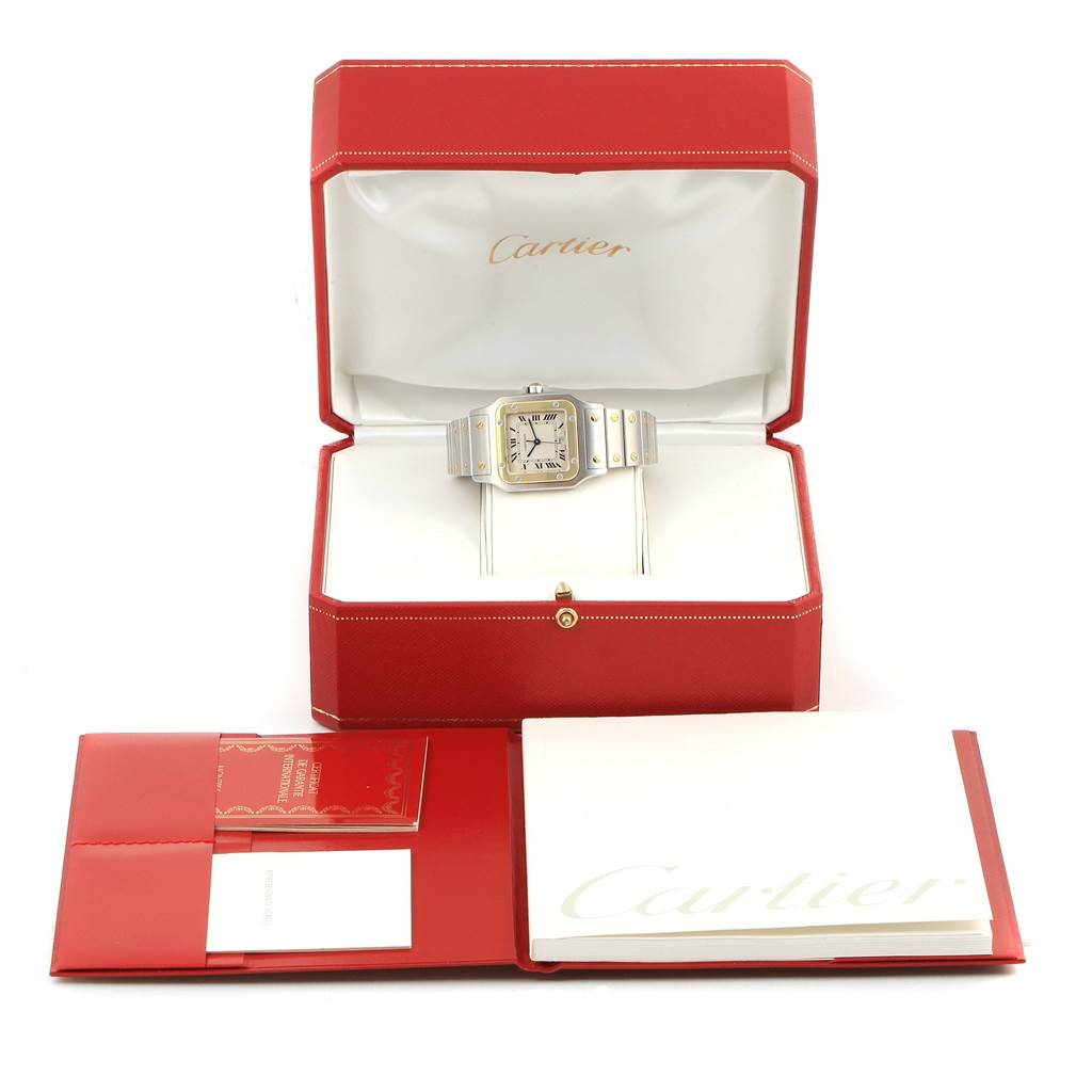 The image shows a Cartier Santos 1566 Stainless Steel Silver Dial 1566 Stainless Steel Silver Dial watch in its open box, along with its documents and warranty cards placed in front.