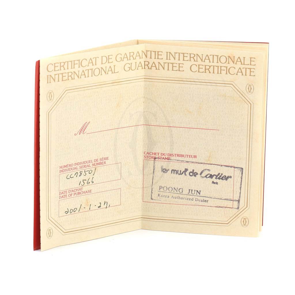 This image shows an international guarantee certificate for a Santos model by Cartier, opened to reveal the serial number and dealer stamp.