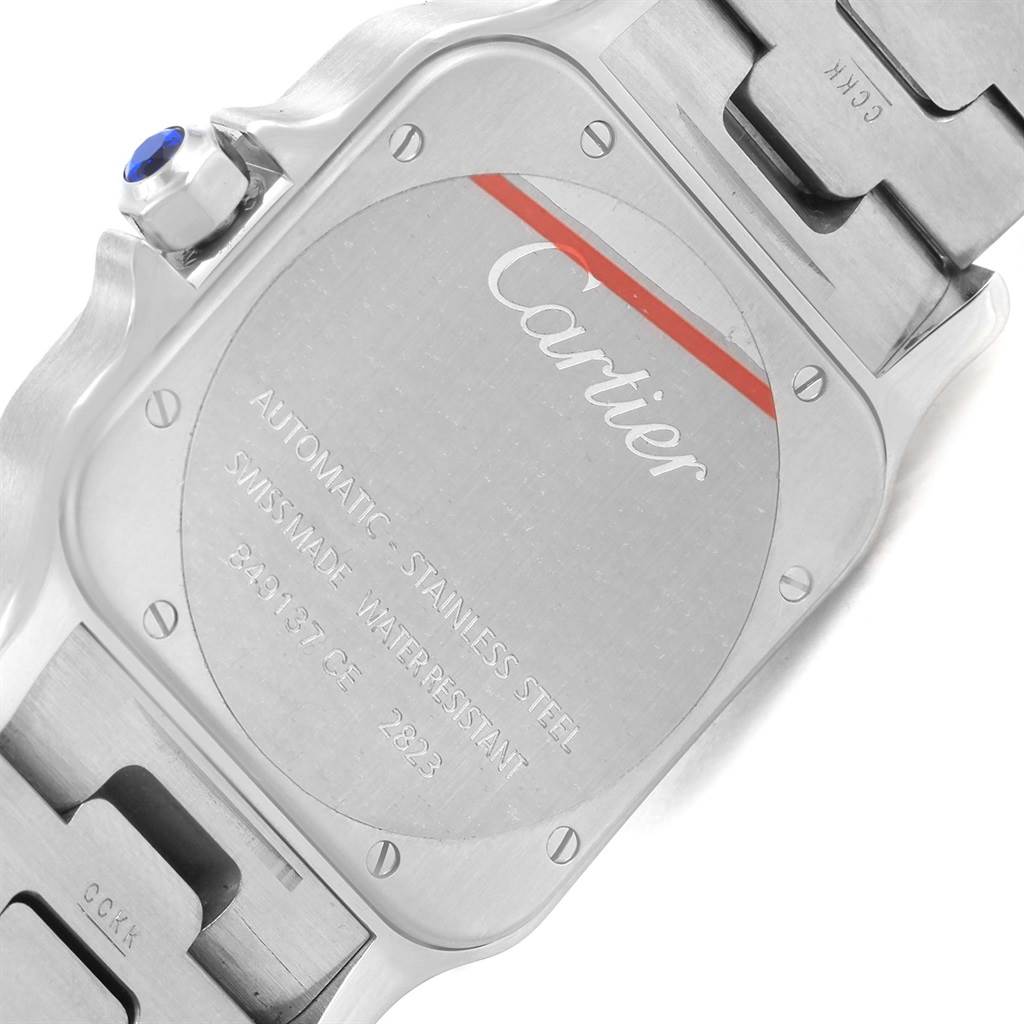 The image shows the back of the Santos model by Cartier, highlighting the case back and part of the bracelet.