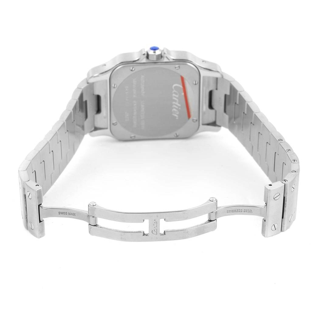 This image shows the back view of a Santos model watch by Cartier, highlighting the case and open metal bracelet clasp.