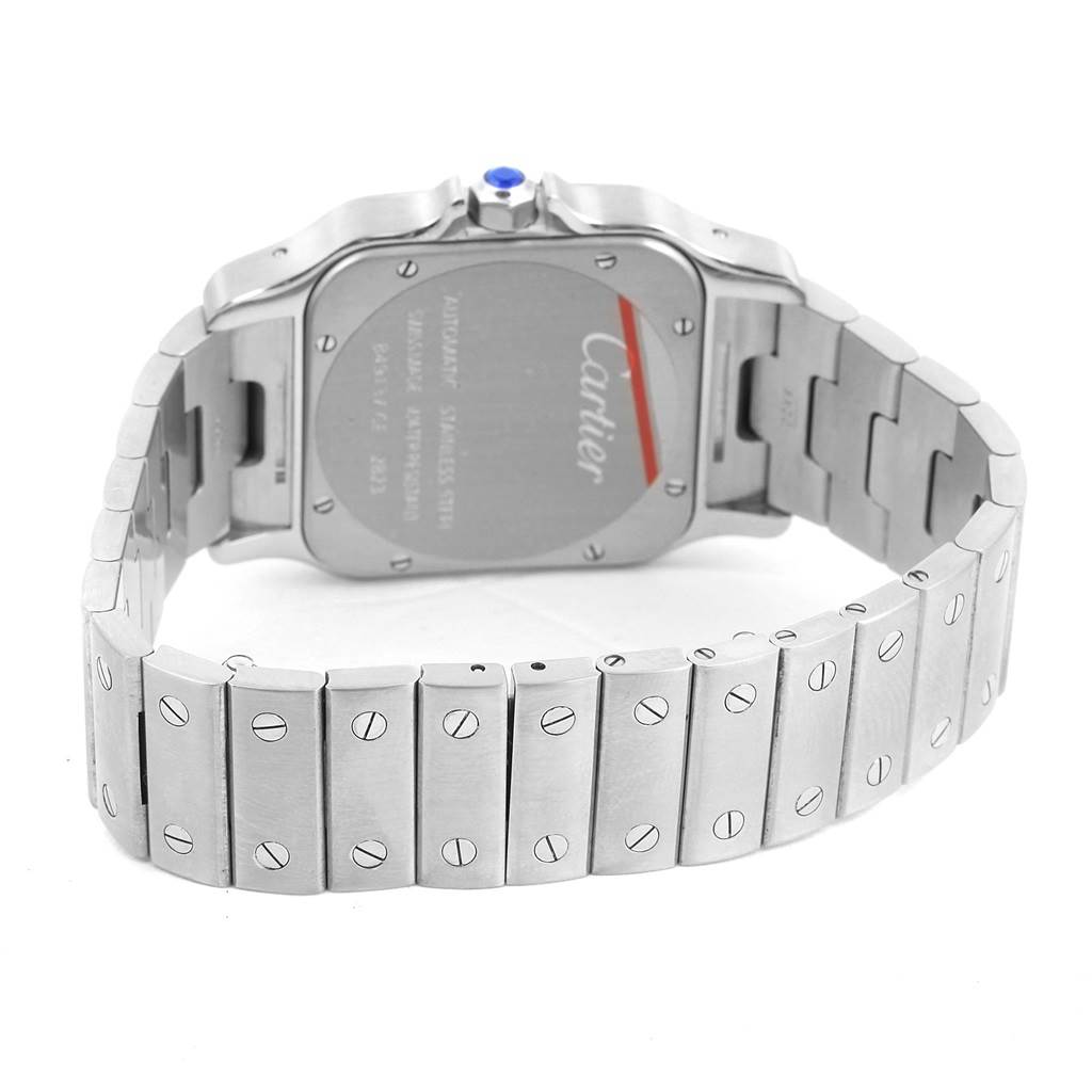 The image shows the back and bracelet of a Santos model watch by Cartier from an angled rear view.