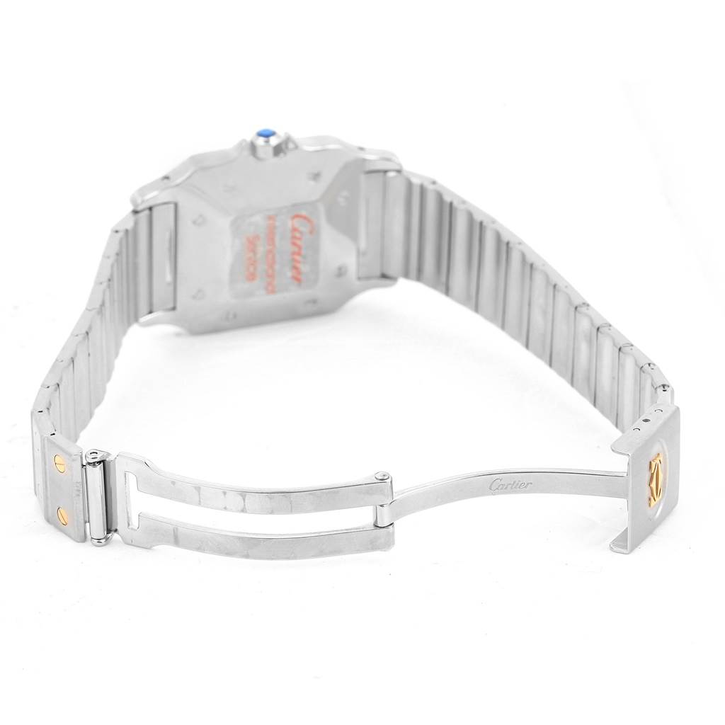 The image shows the back of a Santos model by Cartier with the deployment clasp and bracelet partly open.