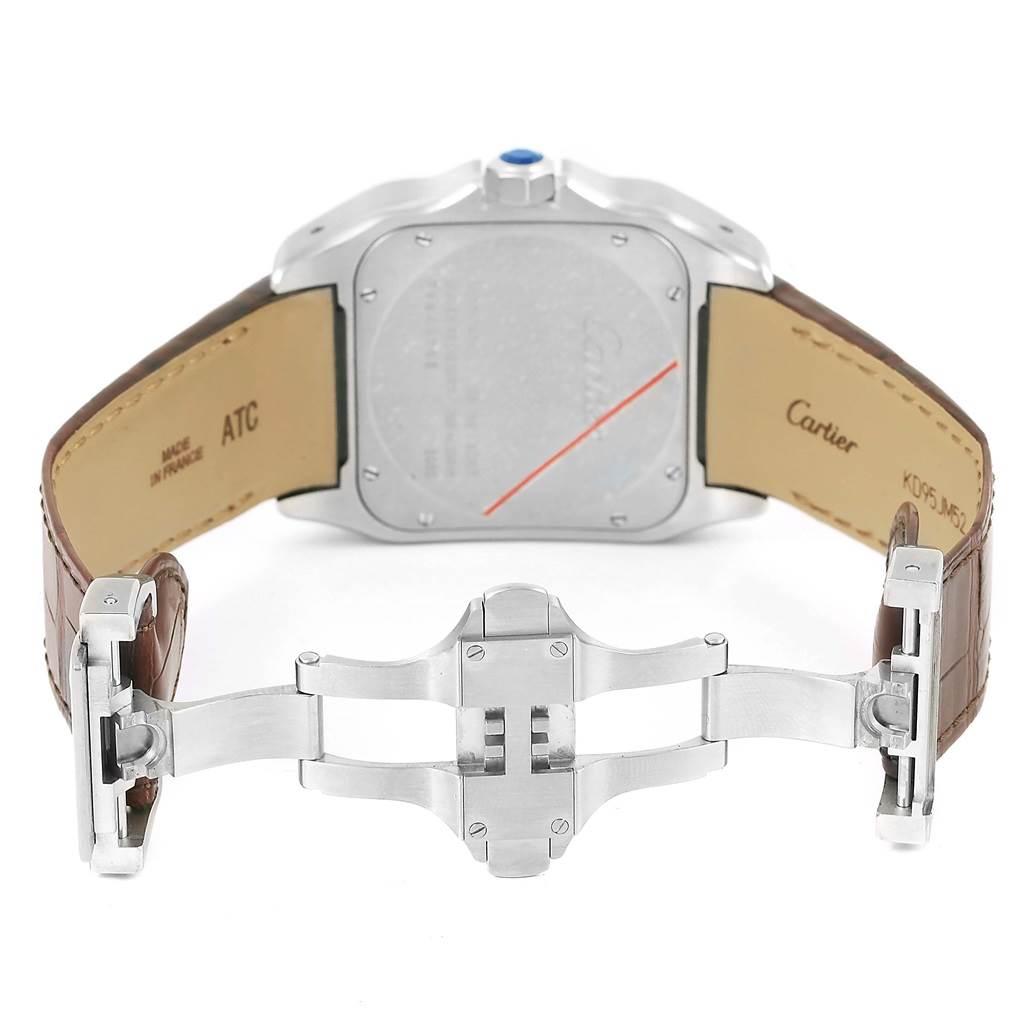 The image shows the back of the Cartier Santos W20072X7 Men
s Stainless Steel Silver Dial W20072X7 Men
s Stainless Steel Silver Dial watch and its open leather strap and clasp mechanism.