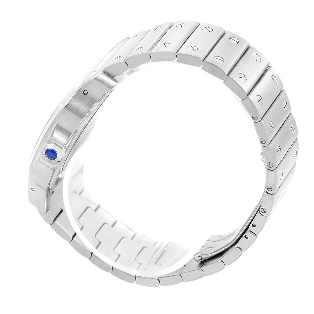 The image shows the side view of the bracelet and part of the case of a Cartier Santos W20098D6 Stainless Steel Silver Dial W20098D6 Stainless Steel Silver Dial watch, highlighting the blue cabochon crown.