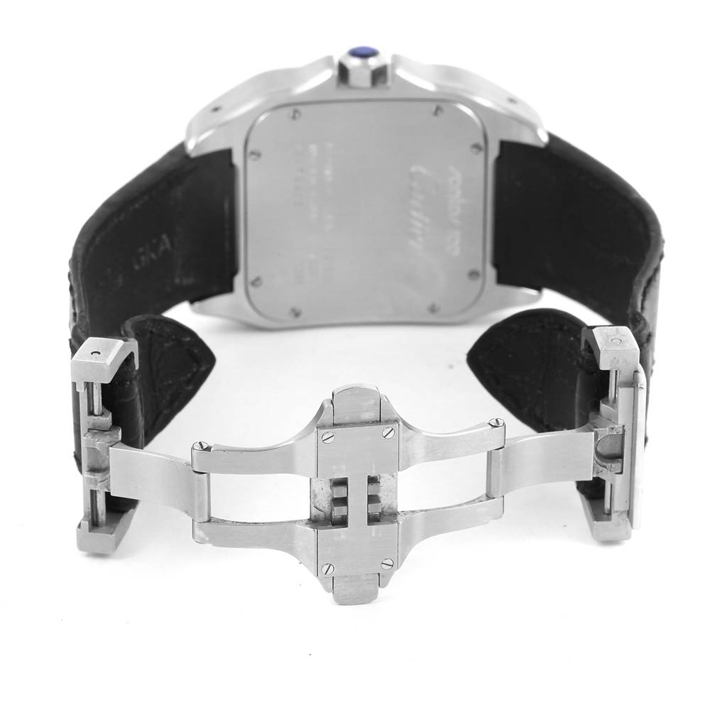 The image shows the back case, crown, and clasp of a Santos model by Cartier watch, with the strap partially opened.