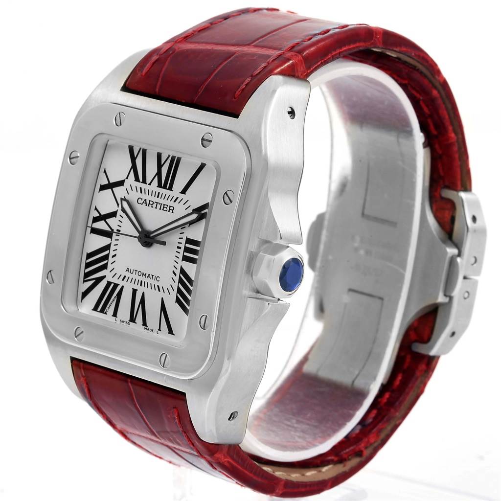The image shows a Cartier Santos W20073X8 Men
s Stainless Steel Silver Dial W20073X8 Men
s Stainless Steel Silver Dial watch from an angled side view, highlighting the dial, case, crown, and red leather strap.
