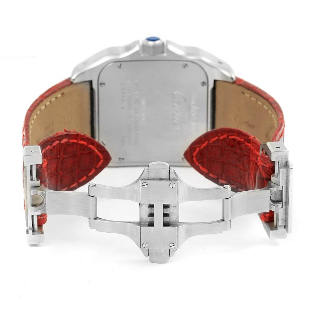 The image shows the back view of a Cartier Santos W20073X8 Men
s Stainless Steel Silver Dial W20073X8 Men
s Stainless Steel Silver Dial watch with a red leather strap and a stainless steel deployment clasp.