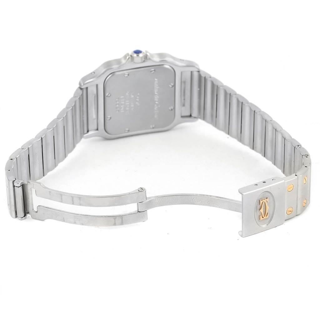 The image shows the back and open clasp of a Santos model by Cartier, highlighting its stainless steel bracelet and logo detail.